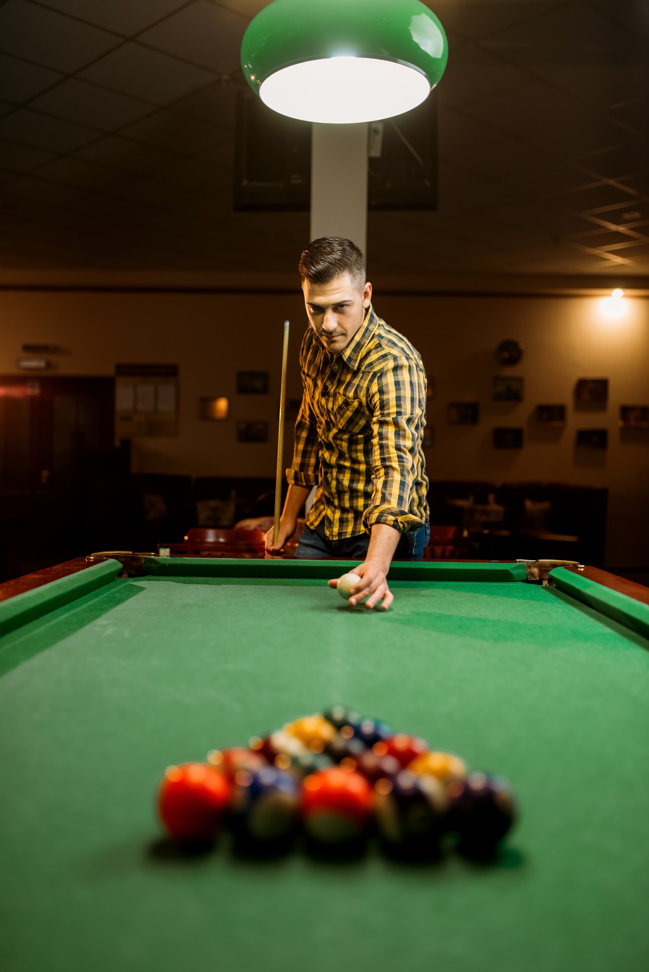 male-billiard-player-with-cue-aiming-at-the-table.jpg